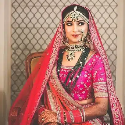 One over the head and the other one brought slantingly, yet low, and assumed control over the elbow Dupatta